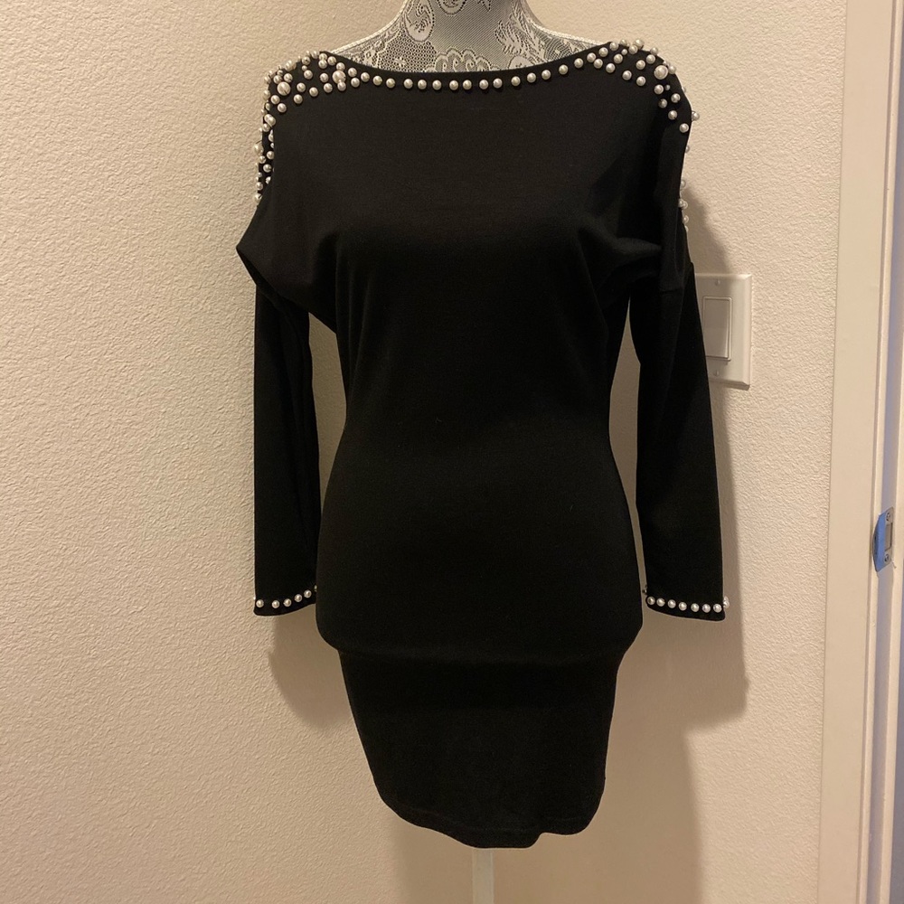Open back contouring mini dress with faux pearls.